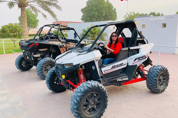 Experience the excitement of self-driving dune buggies in Dubai's stunning desert conquering high red sand dunes while enjoying the beautiful surroundings on a morning adventure.
